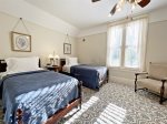 Upper level blue bedroom with two twin beds